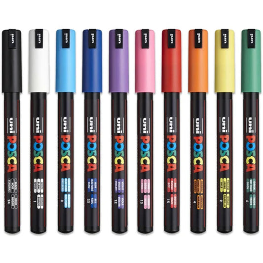 A collection of Posca water-based paint markers with fine tips, displayed in a row with various colors.